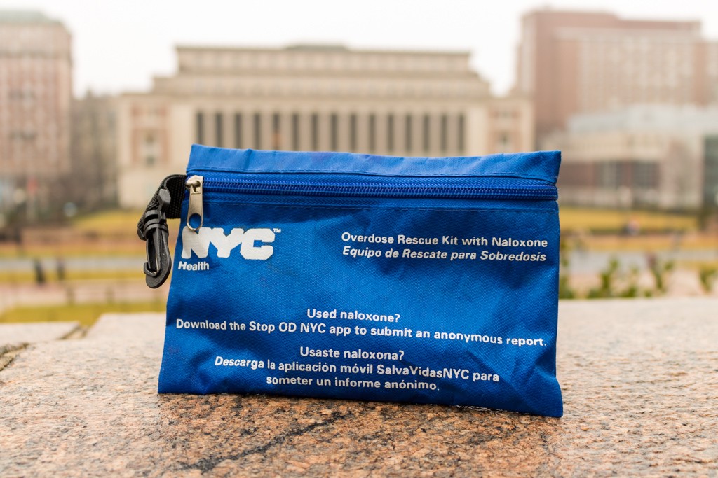 photo of naloxone kit bag sitting on ledge of campus wall