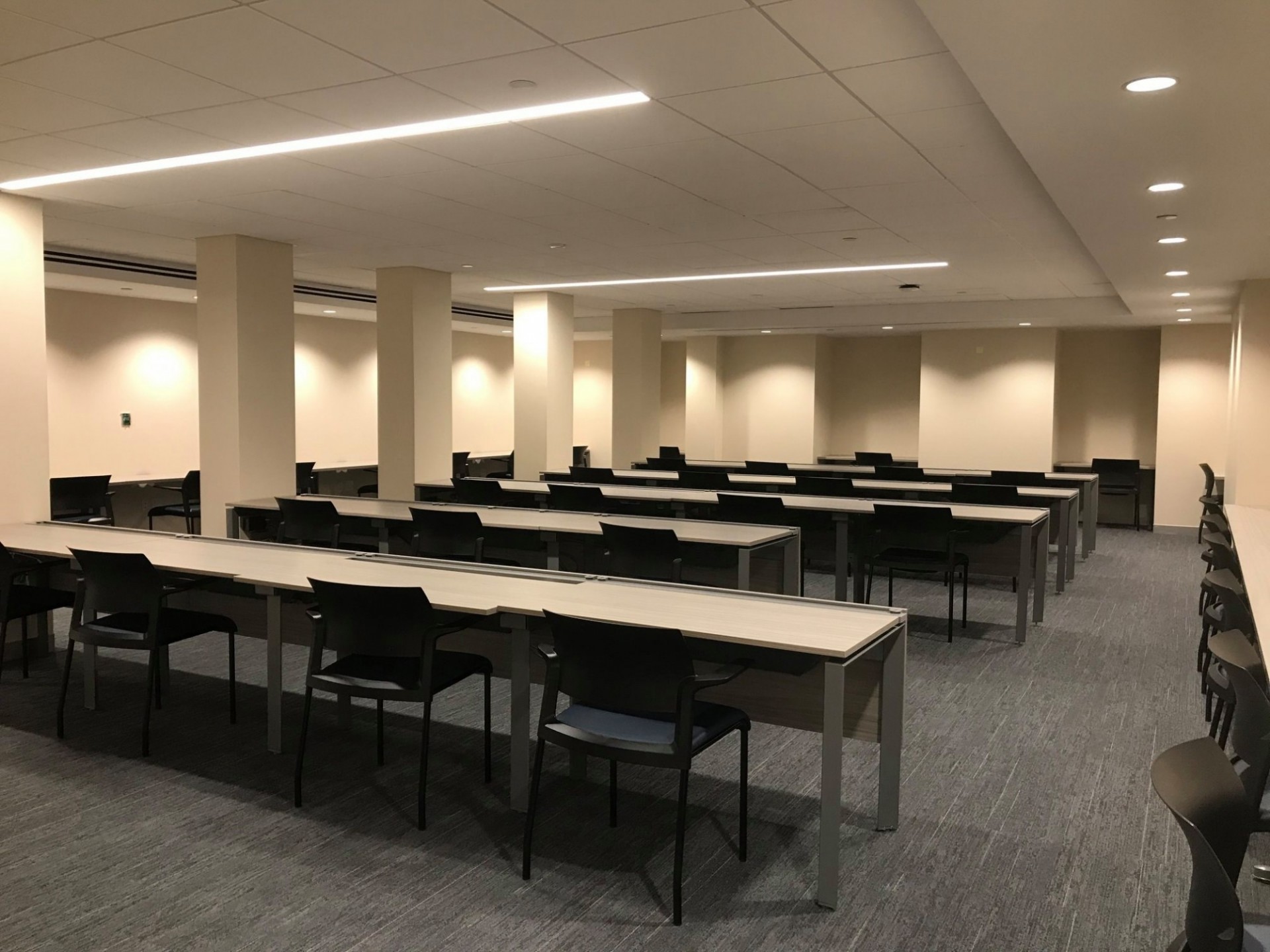 Havemeyer Hall Testing Space Rows of desks and chairs in a well-lit classroom