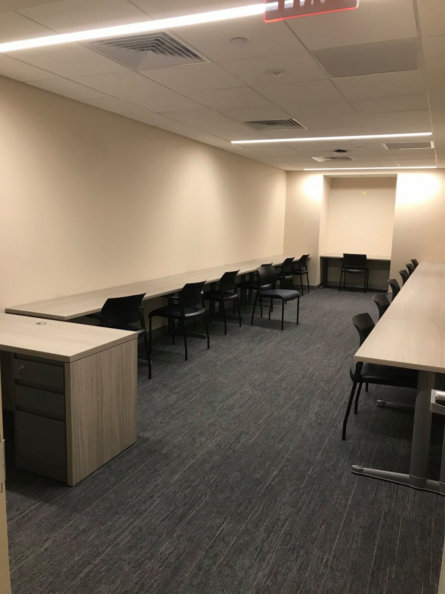 Havemeyer Hall Proctor's Area Narrow well-lit room with tables on all sides and chairs against them